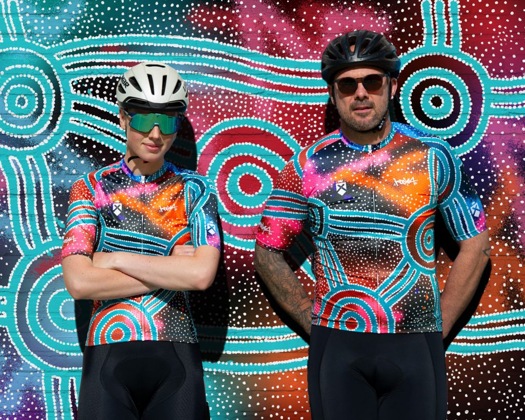 cyclists in indigenous australian designed cycling jerseys